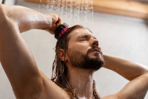 A man using the bathroom faucet