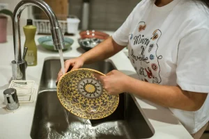 A woman was washing dishes in a double-bowl sink